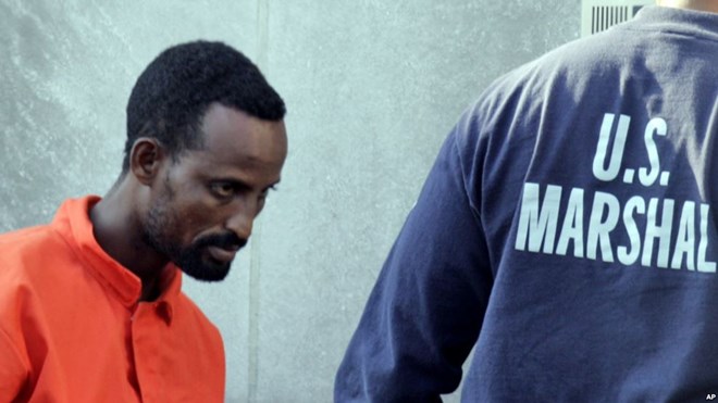 FILE - A suspected pirate from Somalia is escorted into federal court by U.S. Marshals in Norfolk, Virginia, April 23, 2010. Three pirates received sentences on Tuesday.